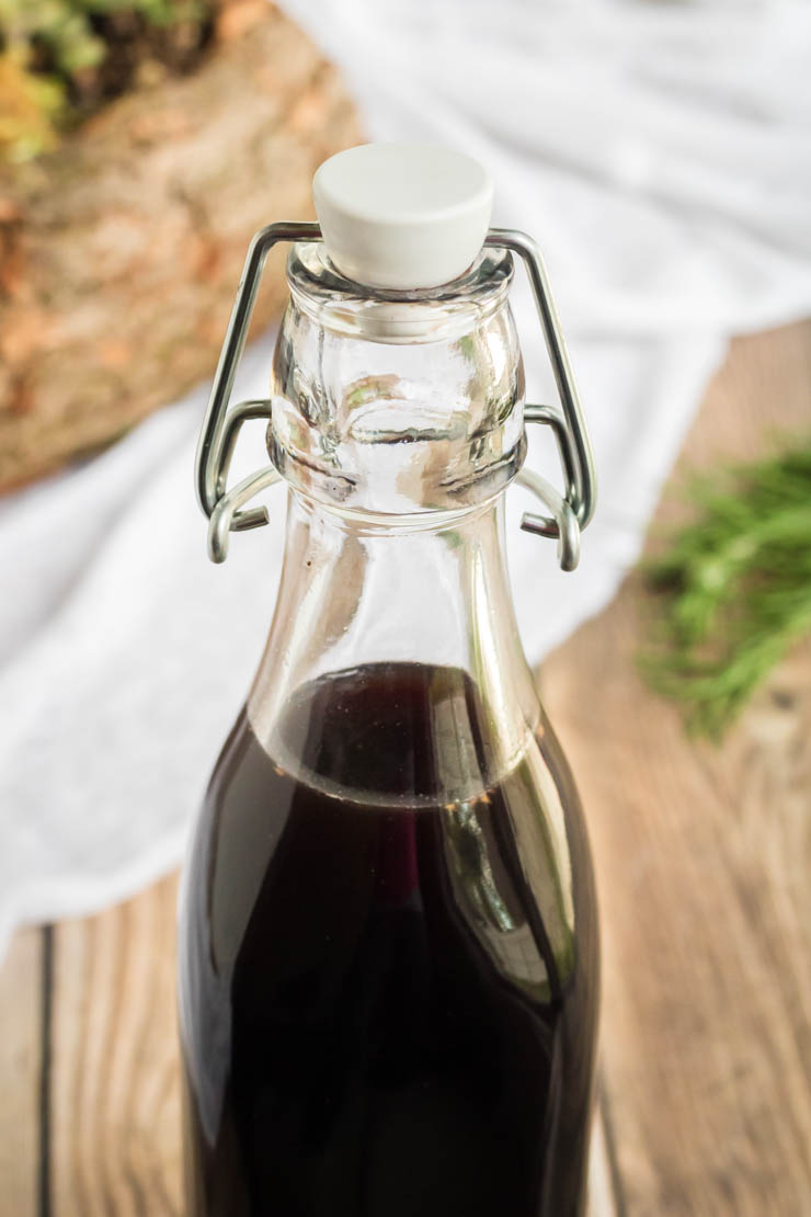 Elderberry Syrup Recipe, the top of a swing cap glass jar of homemade elderberry syrup