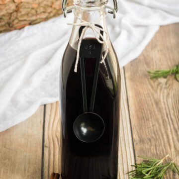 Elderberry Syrup Recipe- a swing top bottle of homemade elderberry syrup