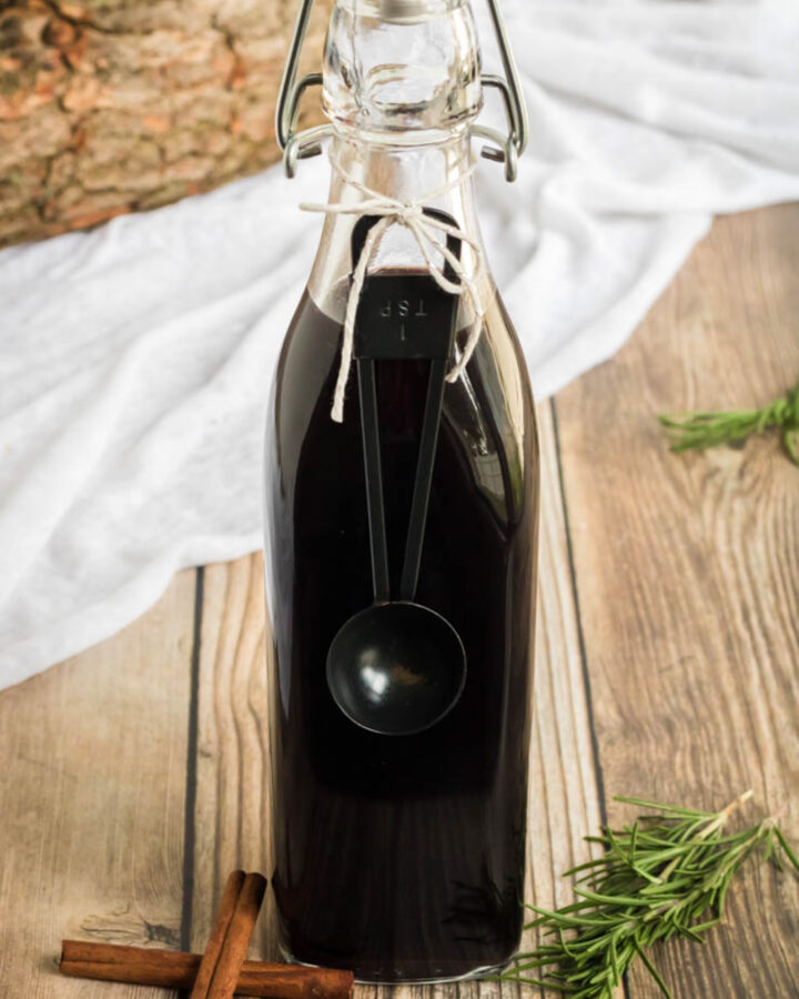 Elderberry Syrup Recipe- a swing top bottle of homemade elderberry syrup