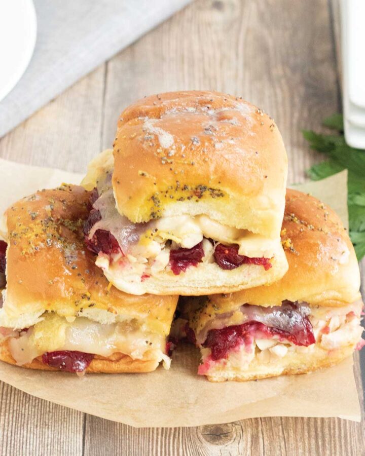 three cranberry turkey sliders baked in the oven.