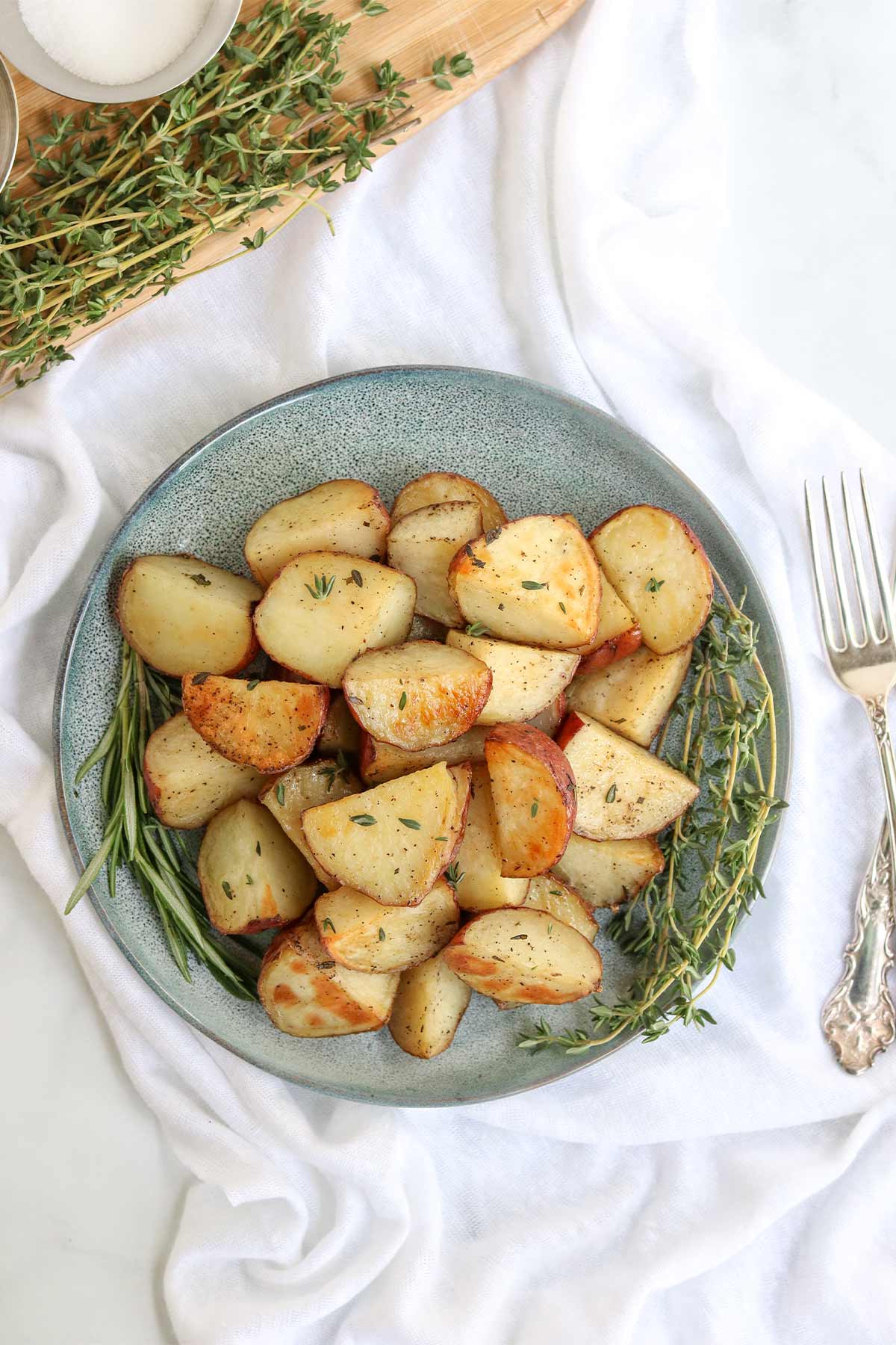 Roasted rosemary potatoes on a plate.