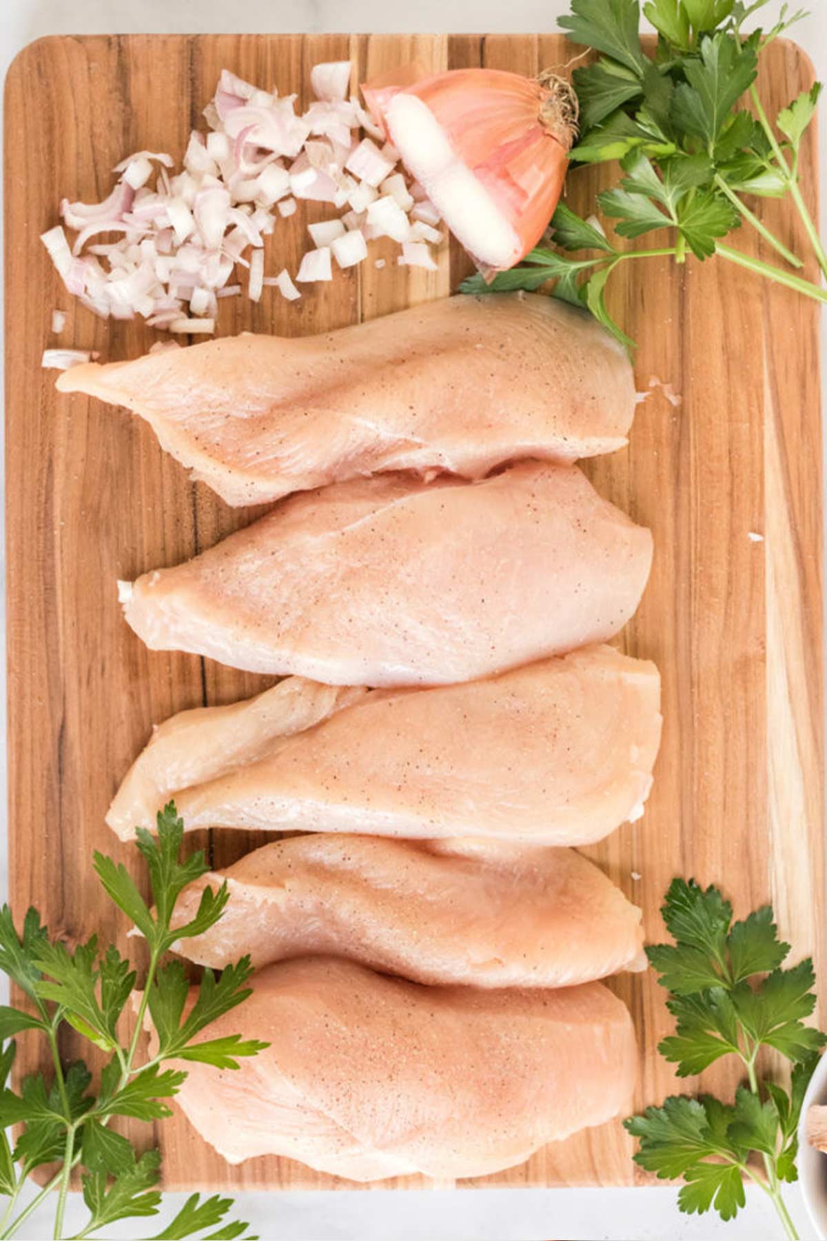 Chicken breasts are trimmed and ready to cook up into Champagne chicken.