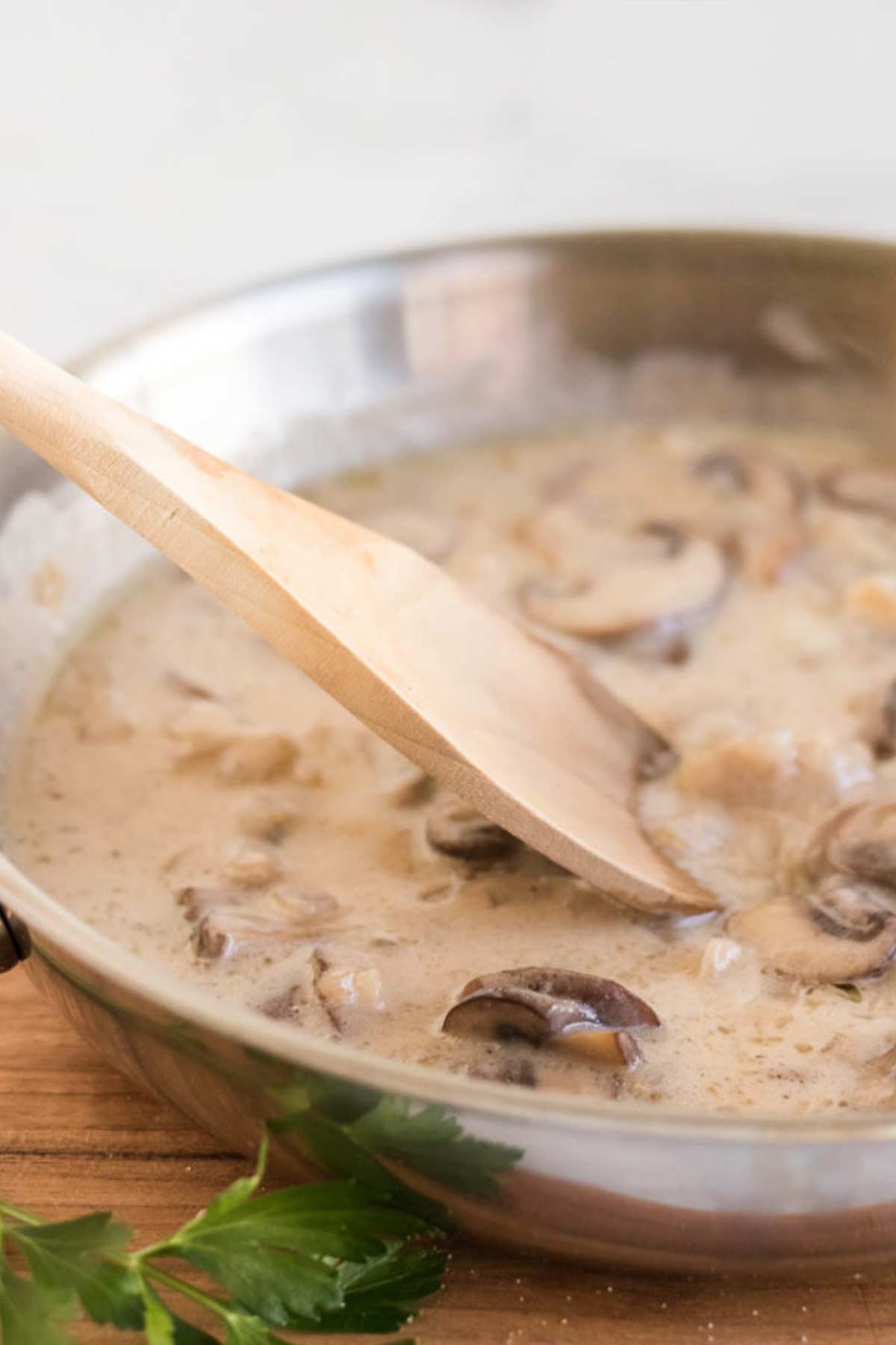 Cooking the sauce for Champagne chicken until creamy.