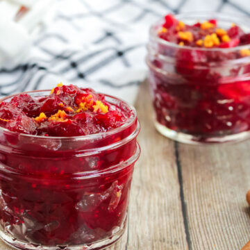 Cranberry orange sauce in a little glass jar with orange zest on top