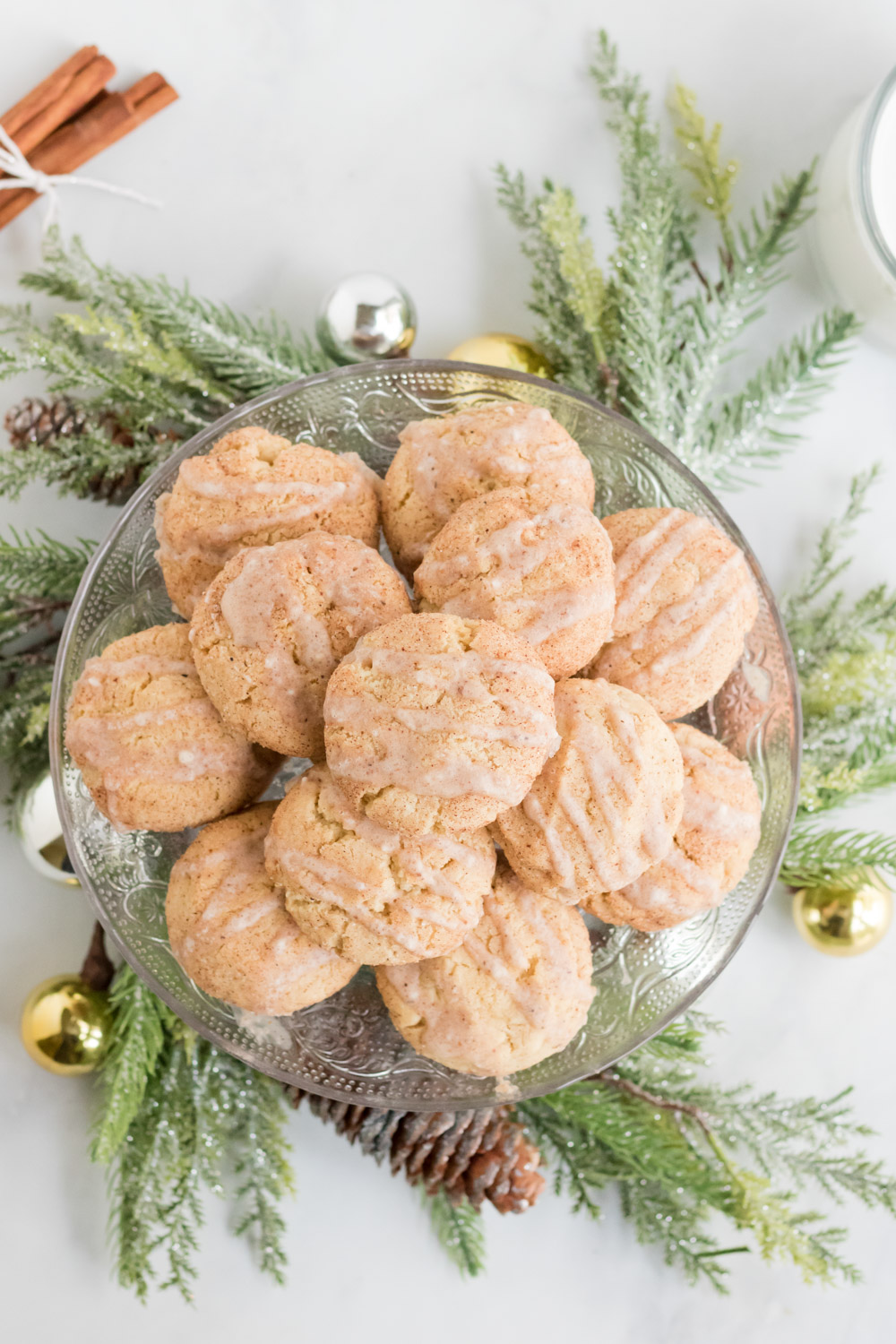 Egg Nog Cookies Recipe- several egg nog cookies sit on a platter with a Christmas Wreath around the base. 
