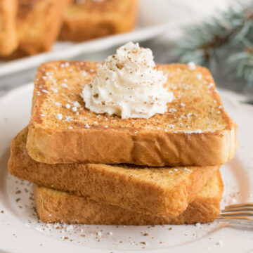 three peices of french toast with whipped cream on top