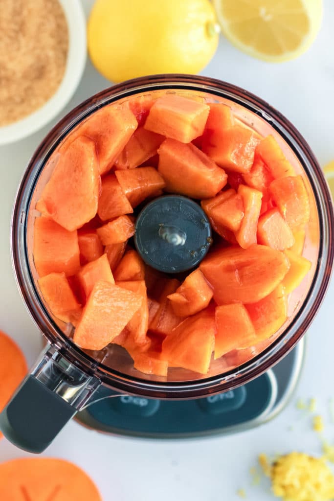 Fuyu Persimmon Butter Recipe, chunks of persimmon fruit in a food processor ready to make butter. 