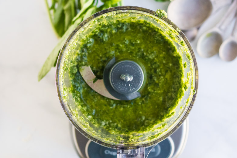 Nut free pesto sauce in a food processor, fully blended. 