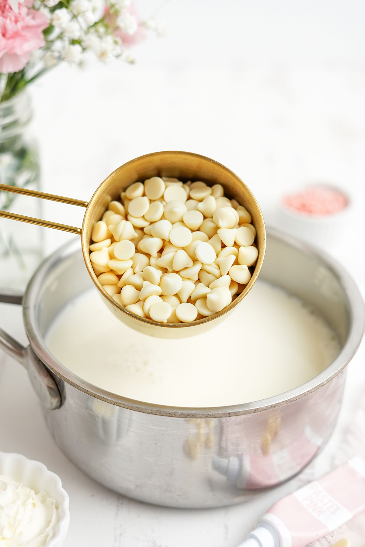 Adding the white chocolate chips to the milk.