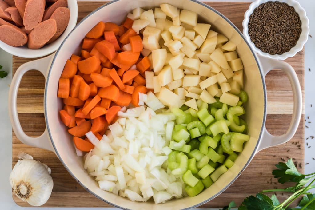 Kartoffelsuppe being prepared in a dutch oven