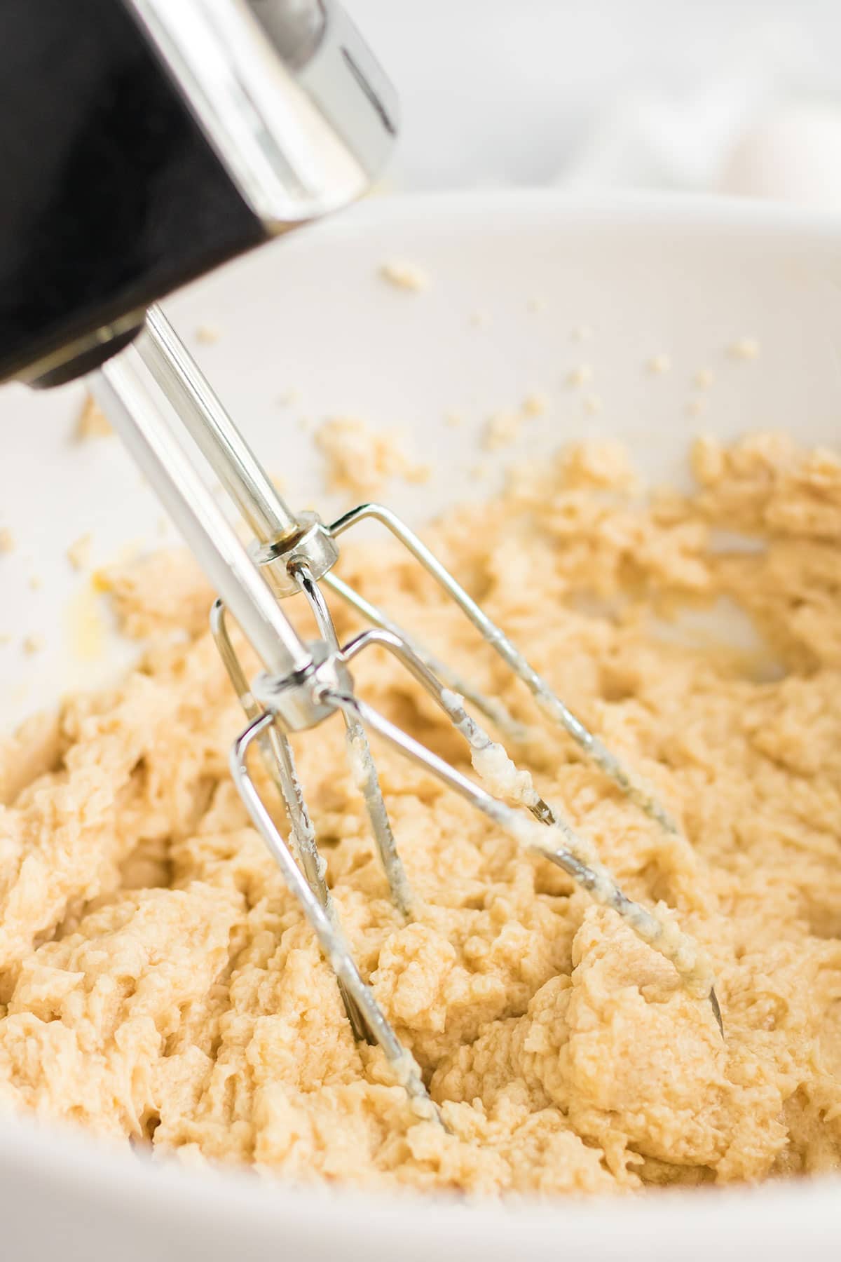 Mixing the batter with an electric mixer.