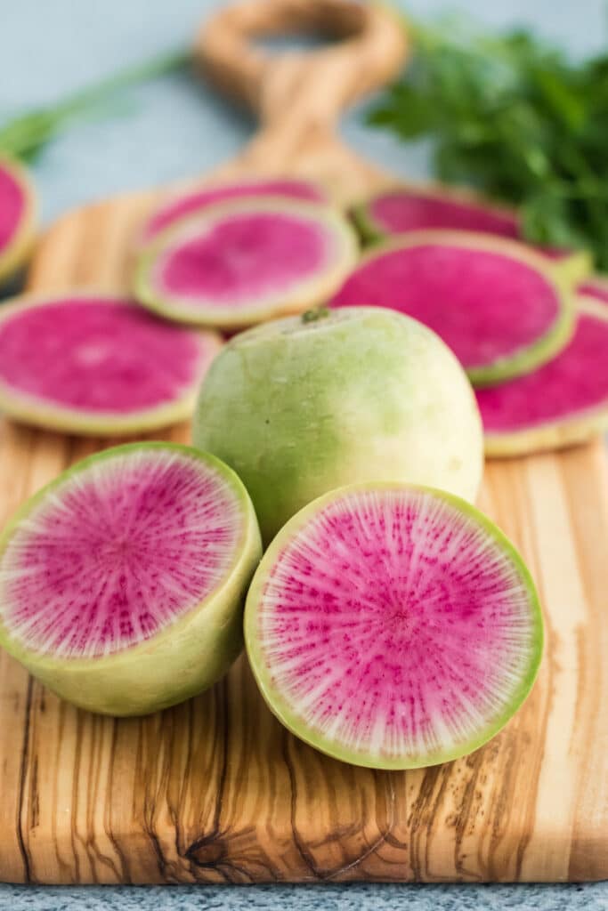 Beautiful watermelon radish sliced open on a cutting board