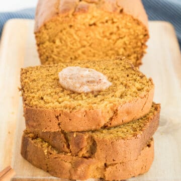 Gluten-free Pumpkin Bread sliced with cinnamon butter on the top slice.