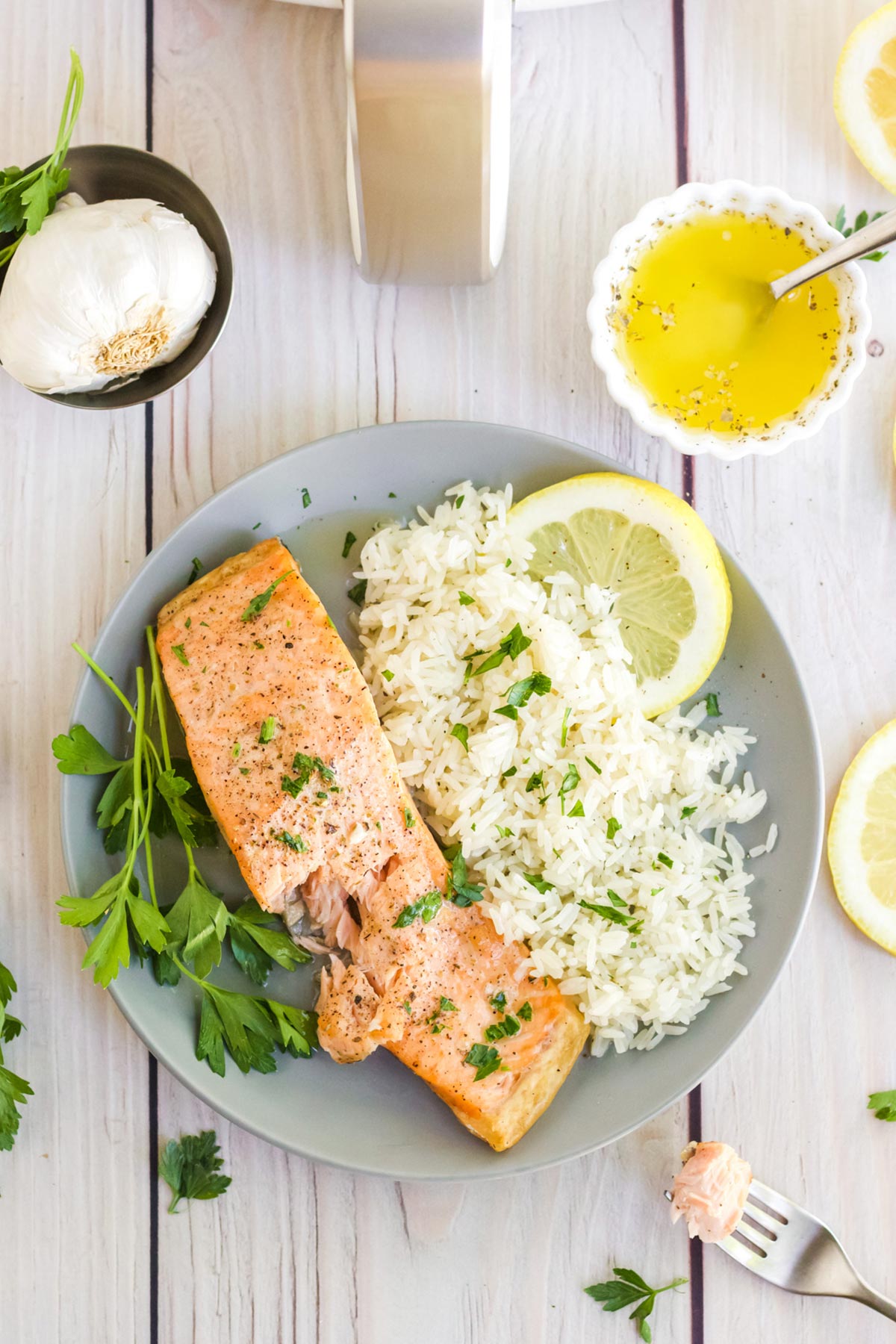 Overhead view of air fryer salmon on a plate with rice.