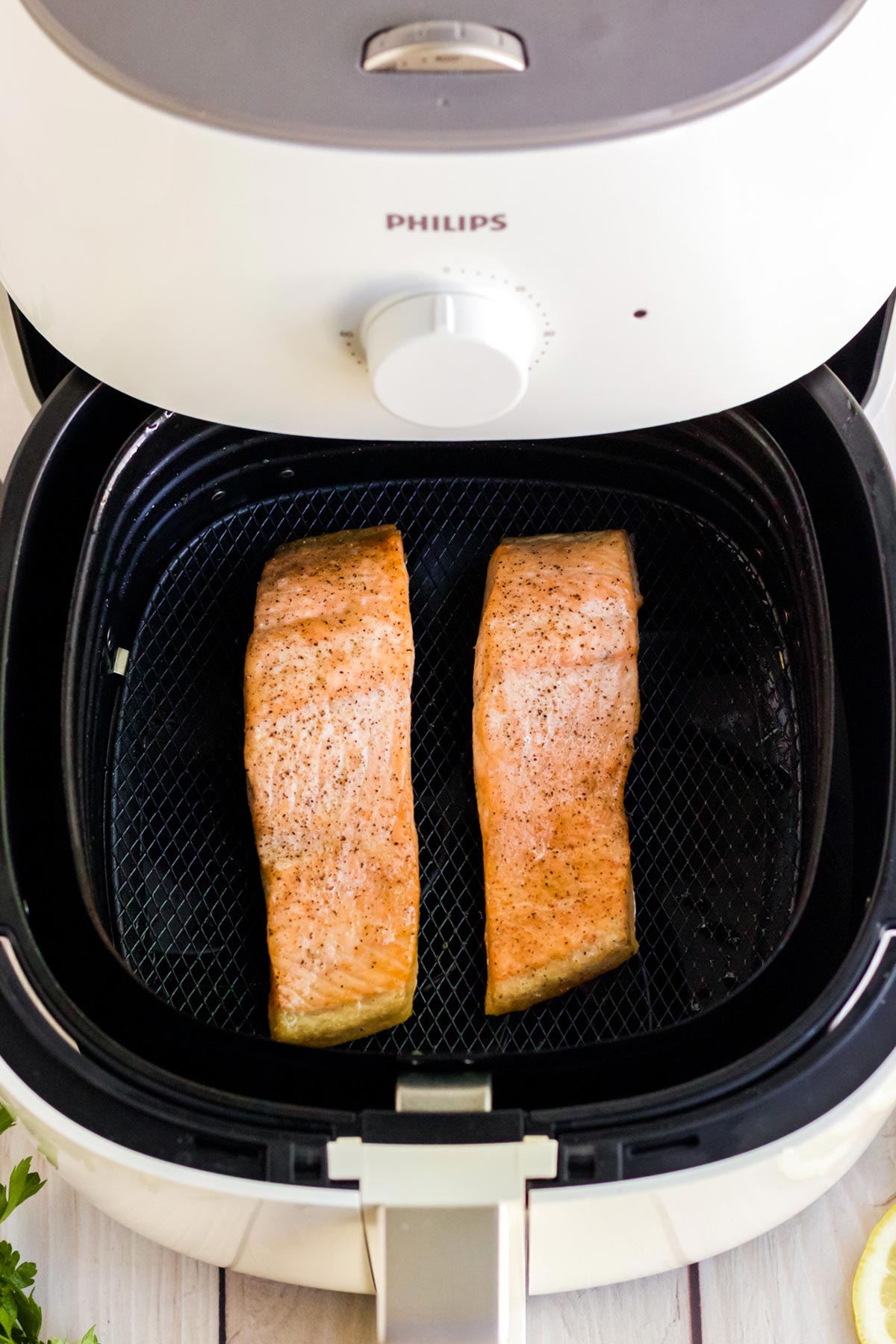 Cooked salmon in the air fryer ready to serve up and eat.