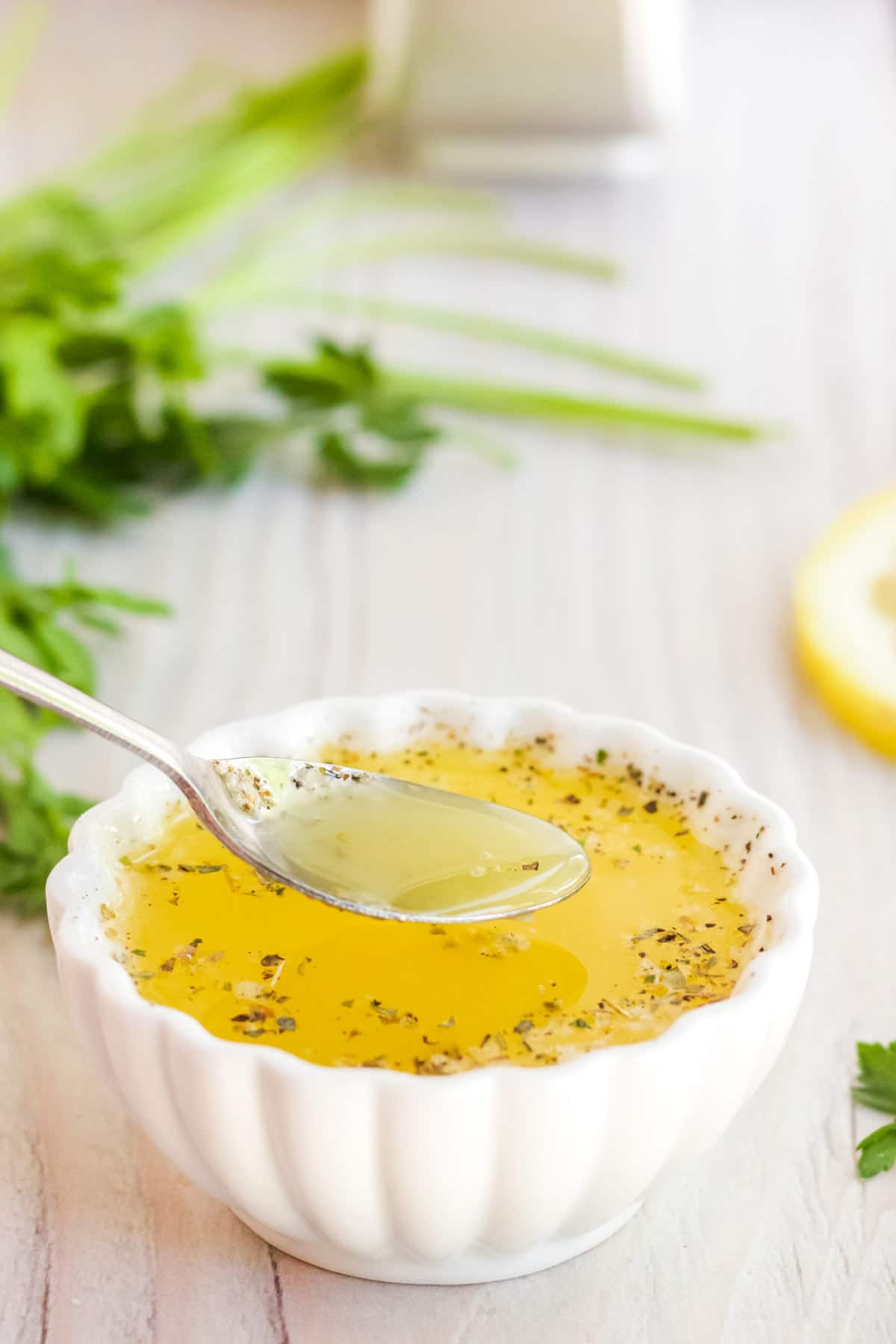 Lemon garlic butter sauce in a small white bowl.