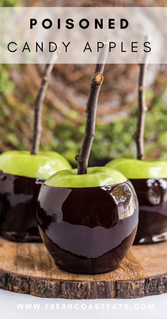 Pinterest Image of Poisoned Candy Apples. Black candy coated granny smith apples with sticks on a wooden serving platter. 