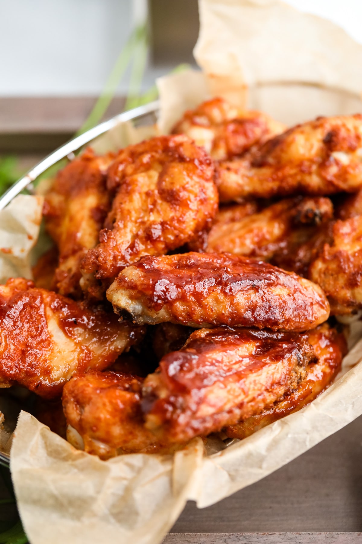 Juicy air fryer bbq chicken wings in a basket.