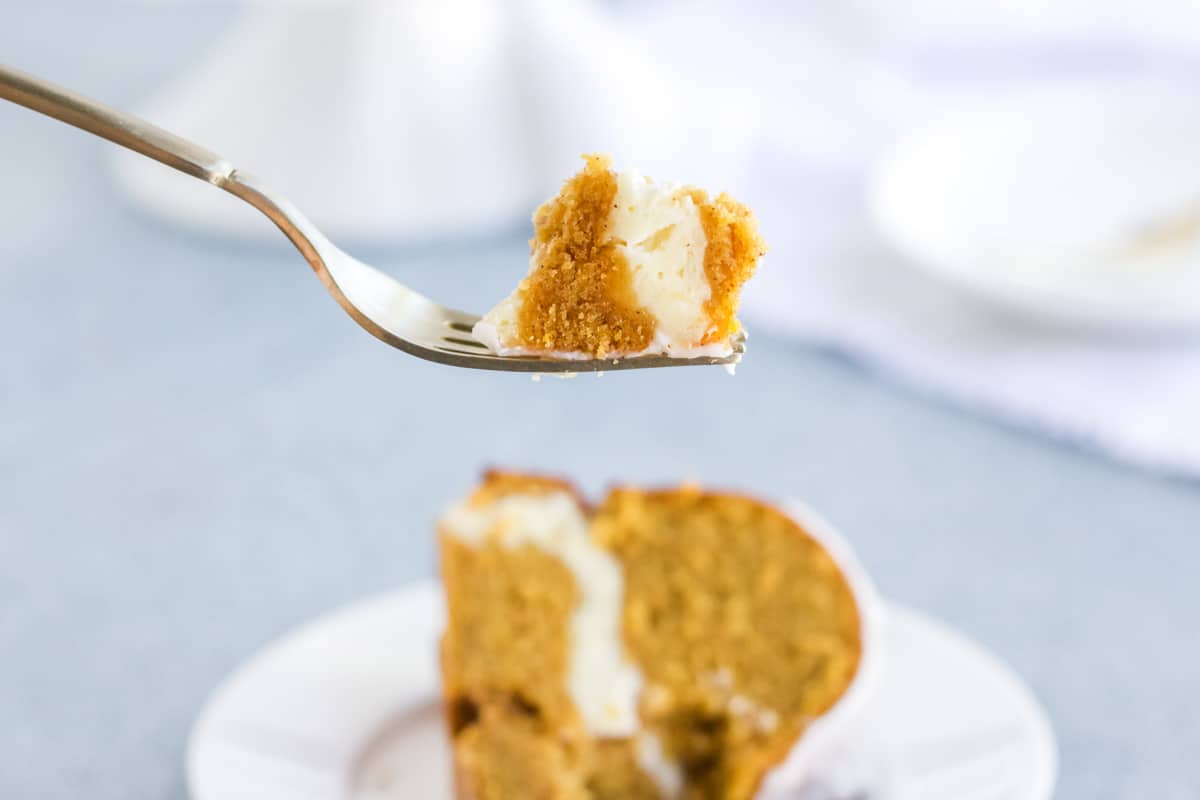 A bite of pumpkin cream cheese pound cake on a fork.