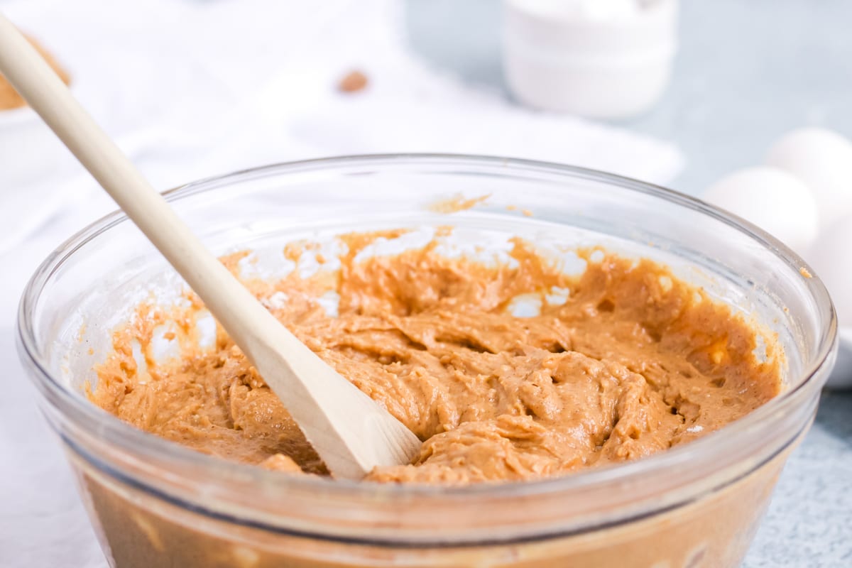 A mixing bowl full of batter for a pumpkin cream cheese pound cake. 