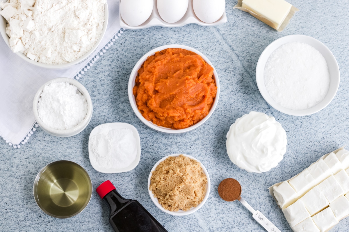 Ingredients for pumpkin cream cheese cake on the table before mixing together.