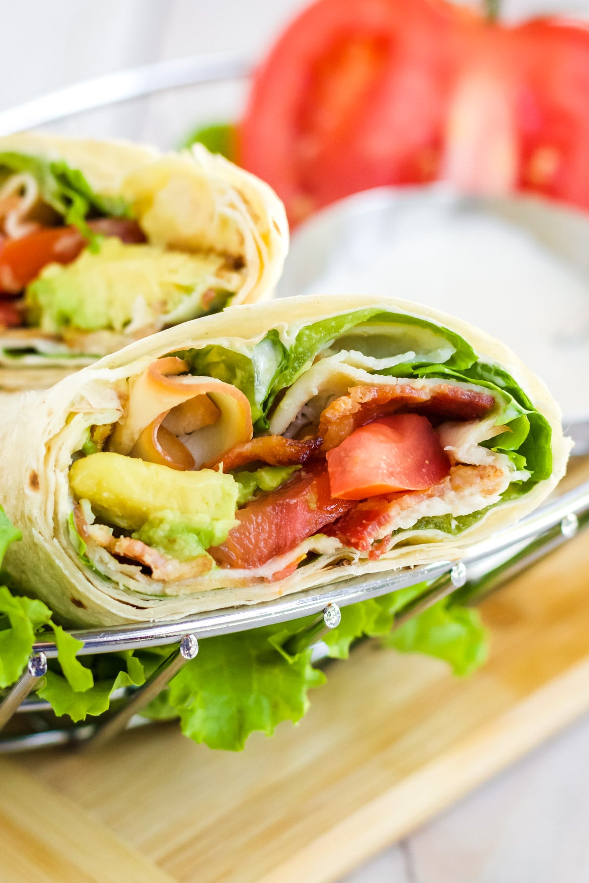 Turkey wrap with bacon served up in a wire basket for lunch.