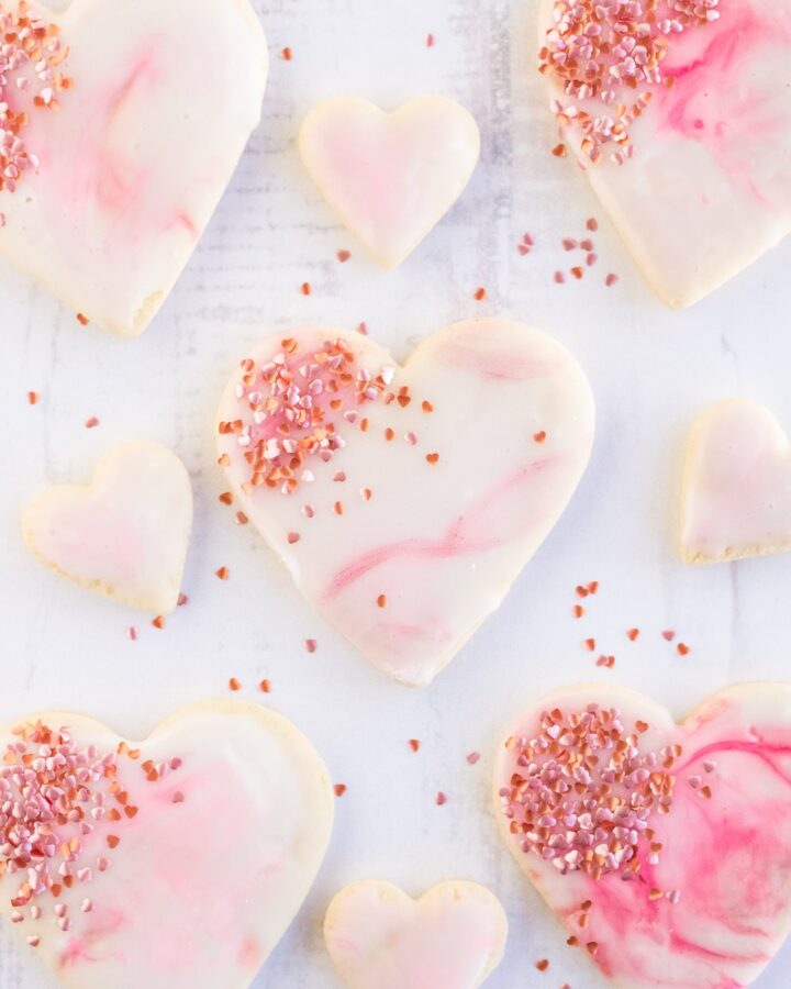 Valentines Cookies with marbled royal icing on a white background