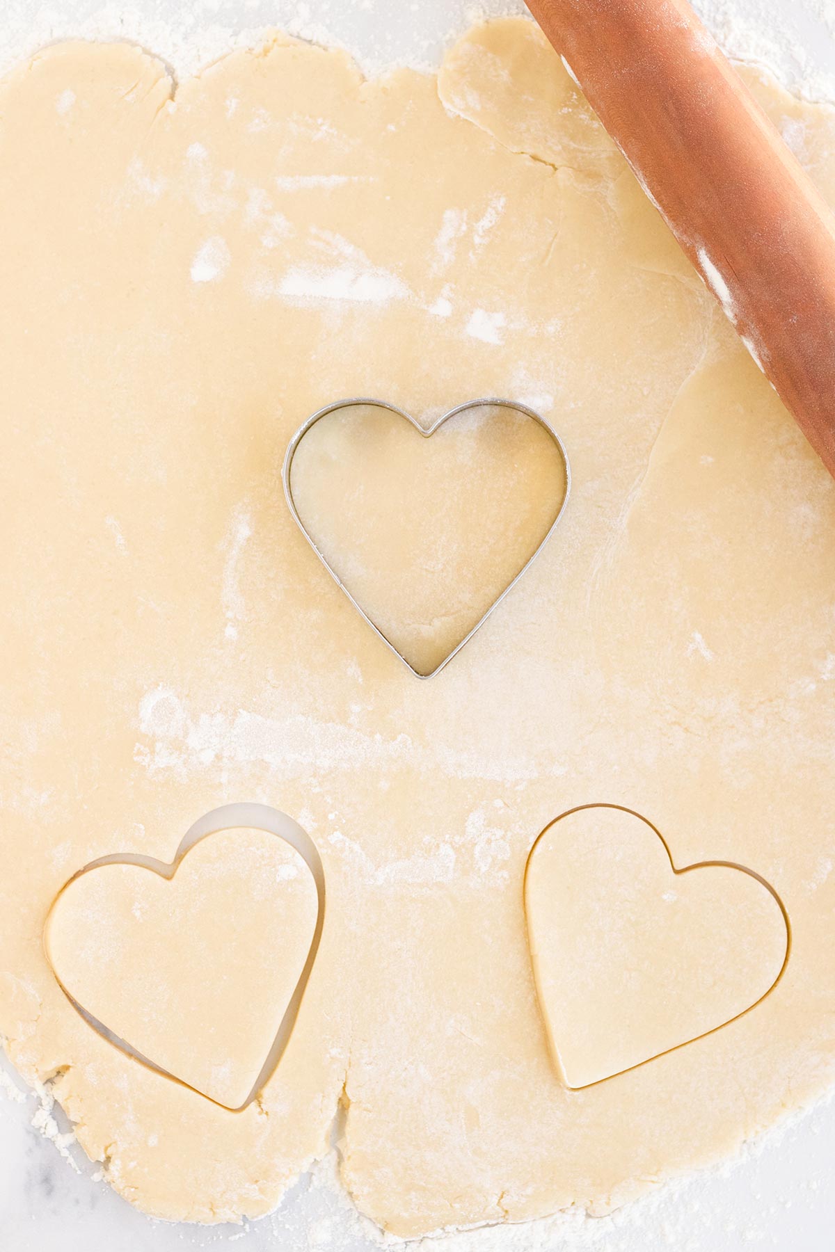 sugar cookie dough cutting out hearts for valentines cookies