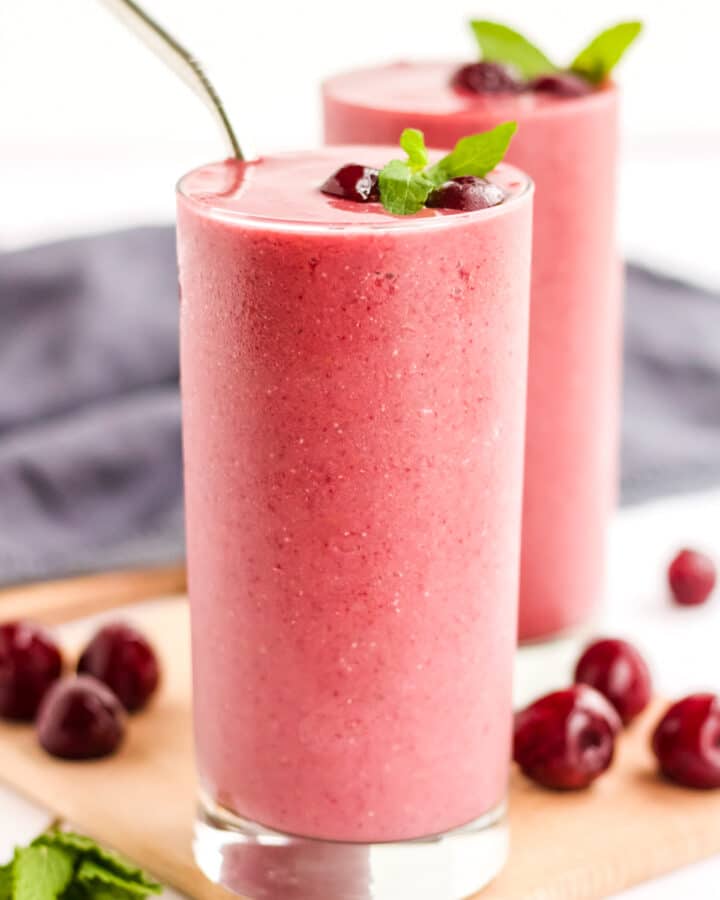 An image of two cherry smoothies.