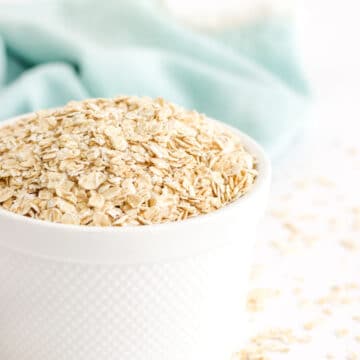A white bowl of oats in preparation to make homemade oat flour.