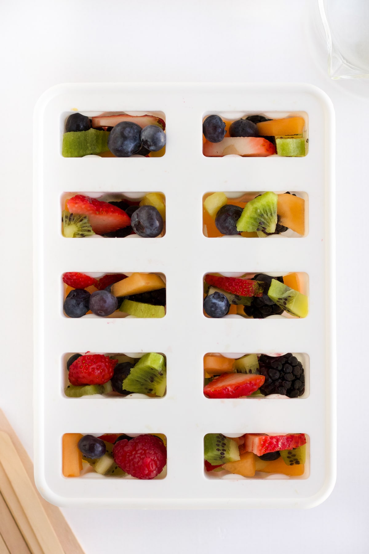 overhead shot of fruit popsicles ready to go in the freezer