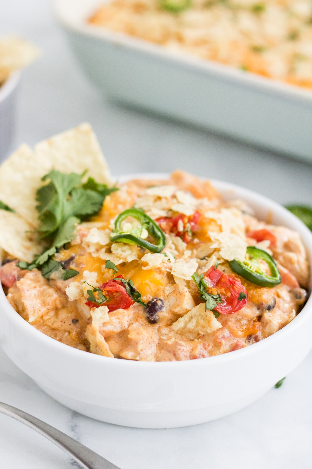 A 45 degree image of chicken taco casserole in a white bowl. 