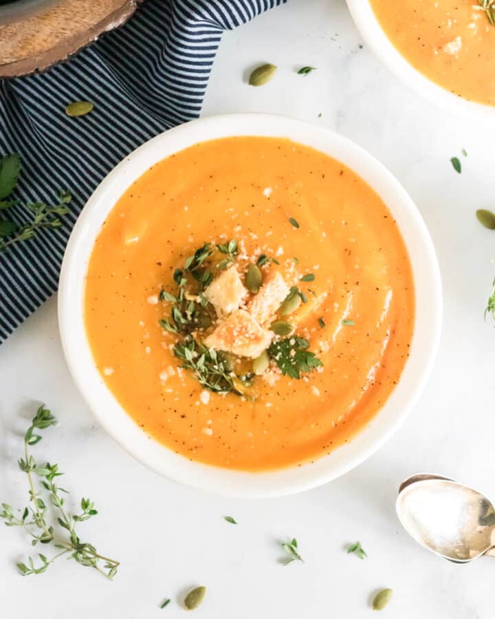 an overhead image of a bowl of vegan butternut squash soup