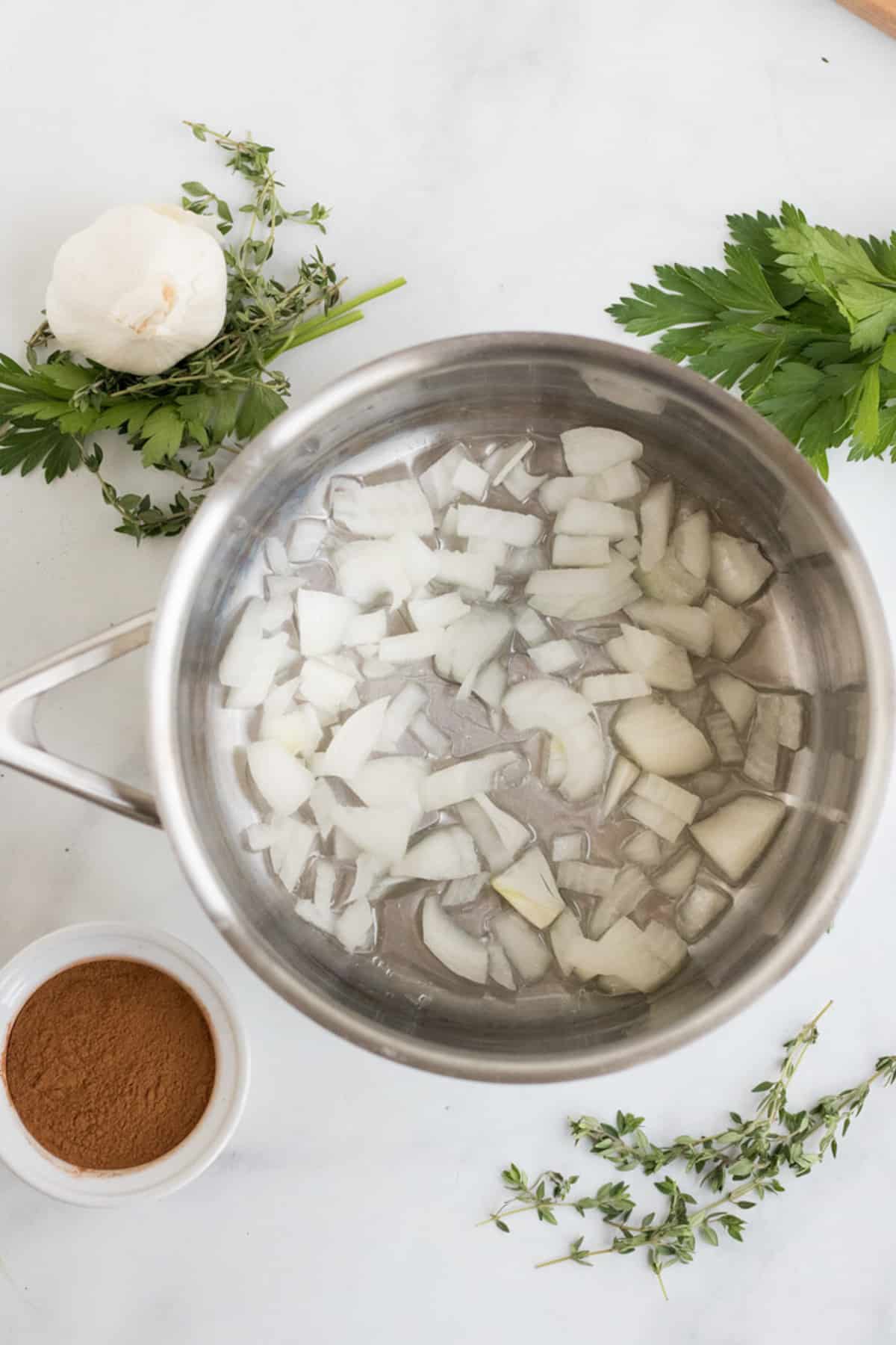 onions and garlic sauteed in frying pan for soup