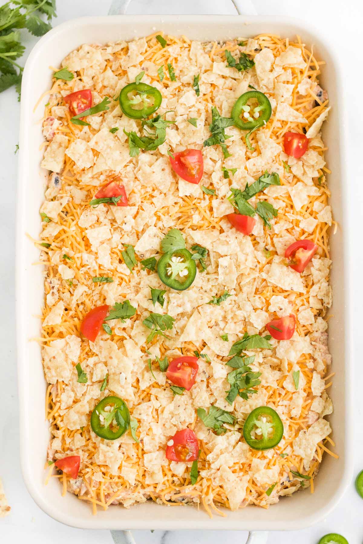 Chicken taco casserole in the dish ready for the oven.