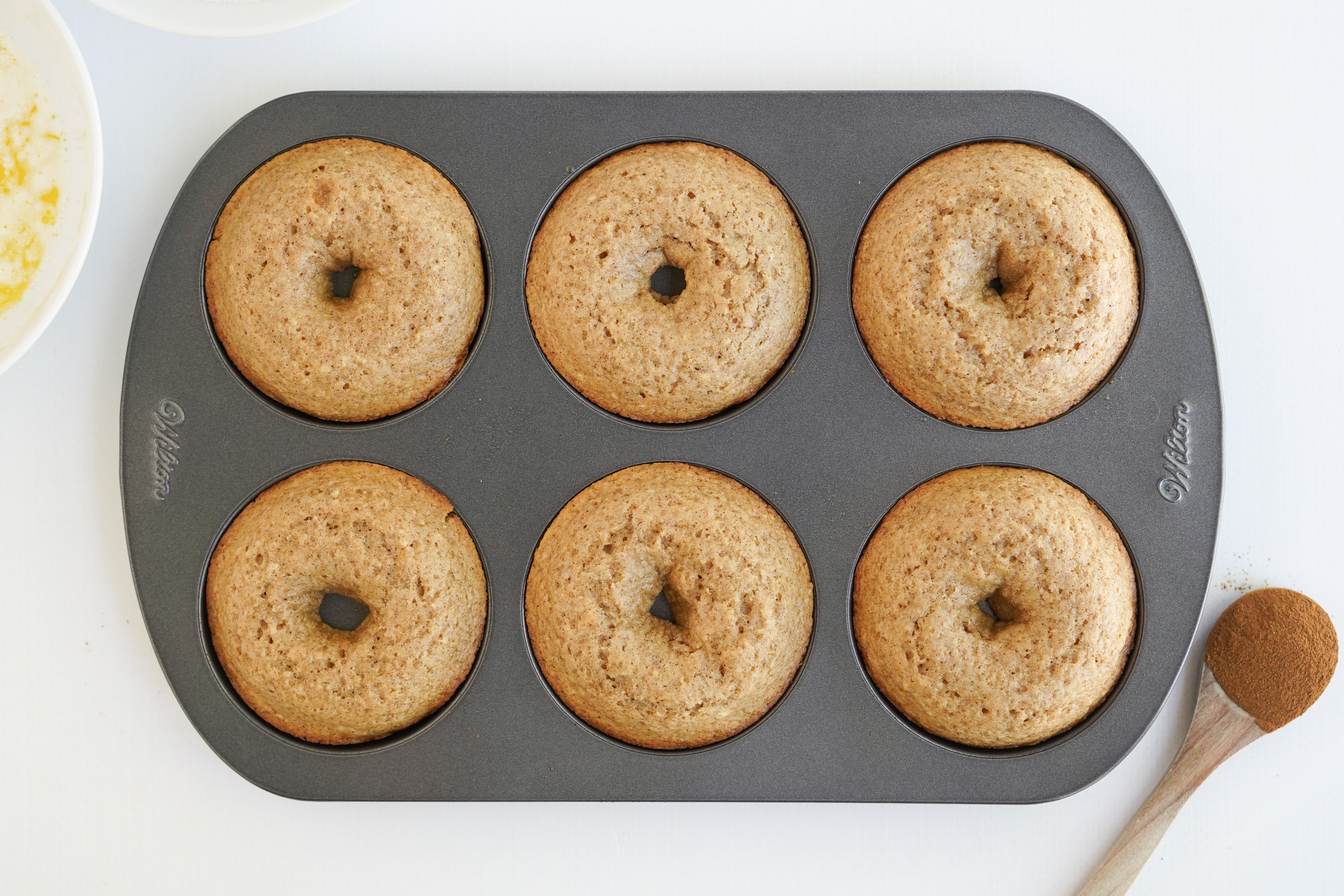 freshly baked apple cider doughnuts in pan