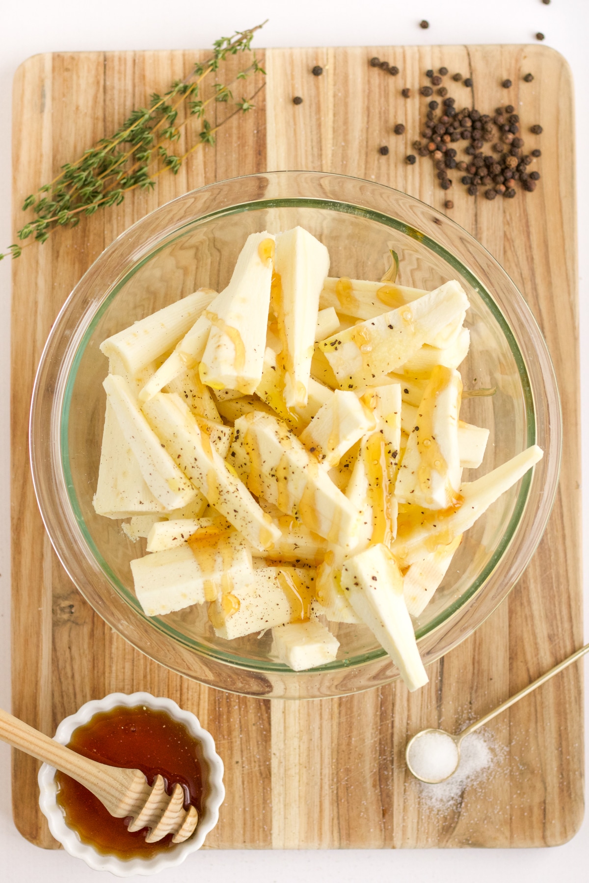 cut parsnips in a glass bowl with other ingredients