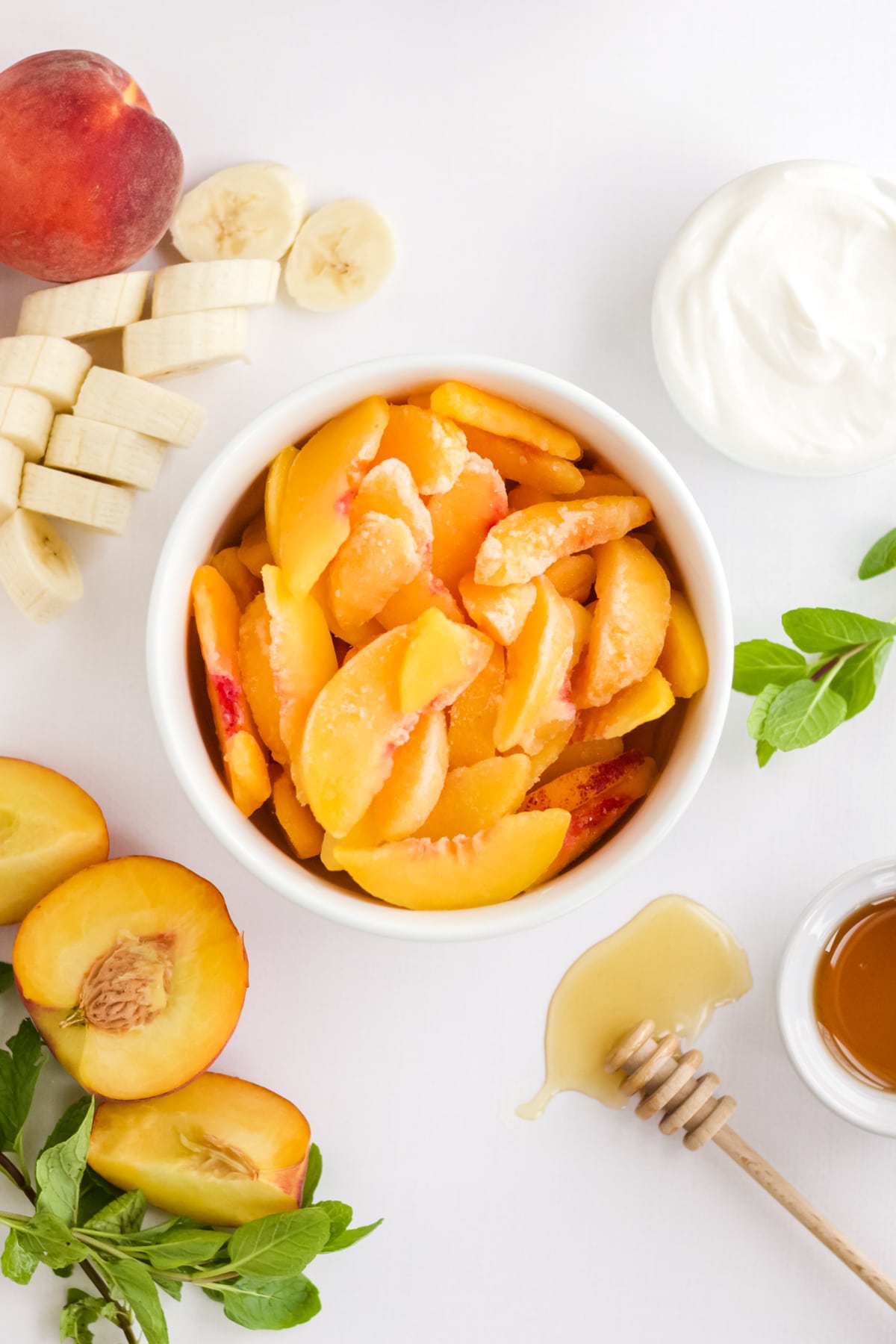 Ingredients to make a banana peach smoothie.