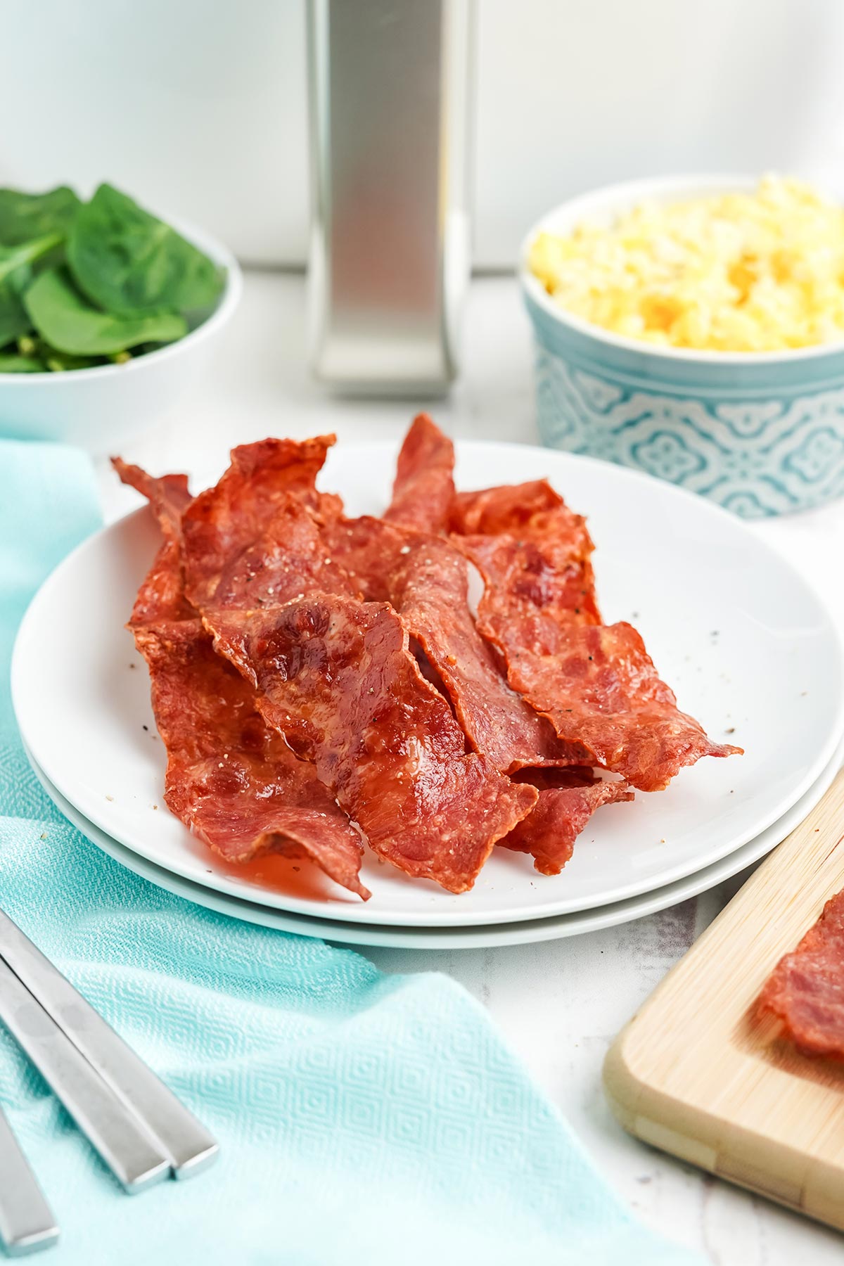 Air fryer turkey bacon served up on a white plate.