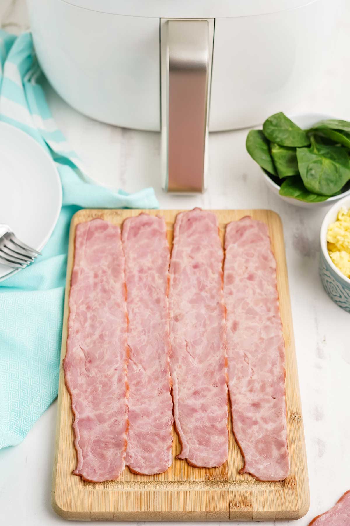 Ingredients and equipment to make air fryer turkey bacon.