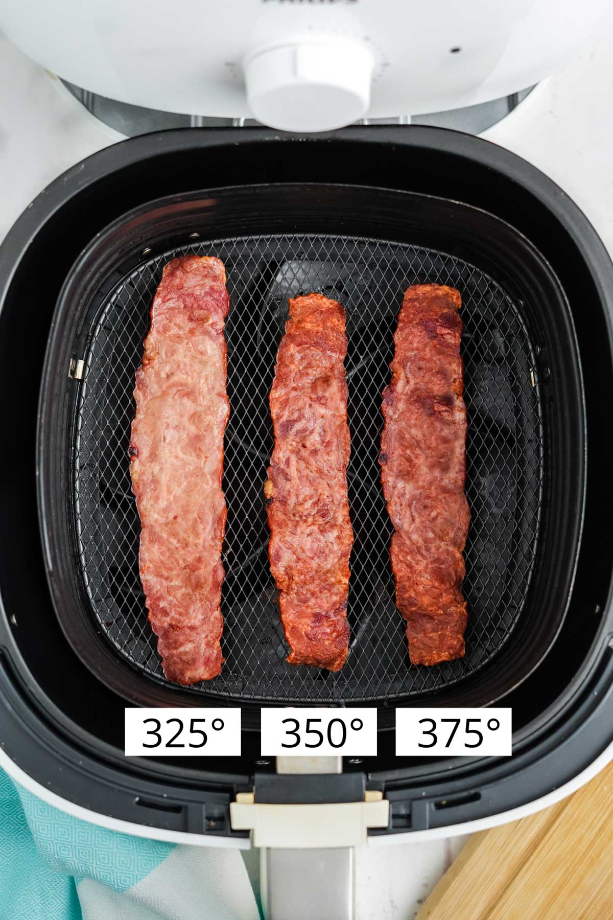 Three strips of turkey bacon showing the outcomes of cooking at different temperatures.