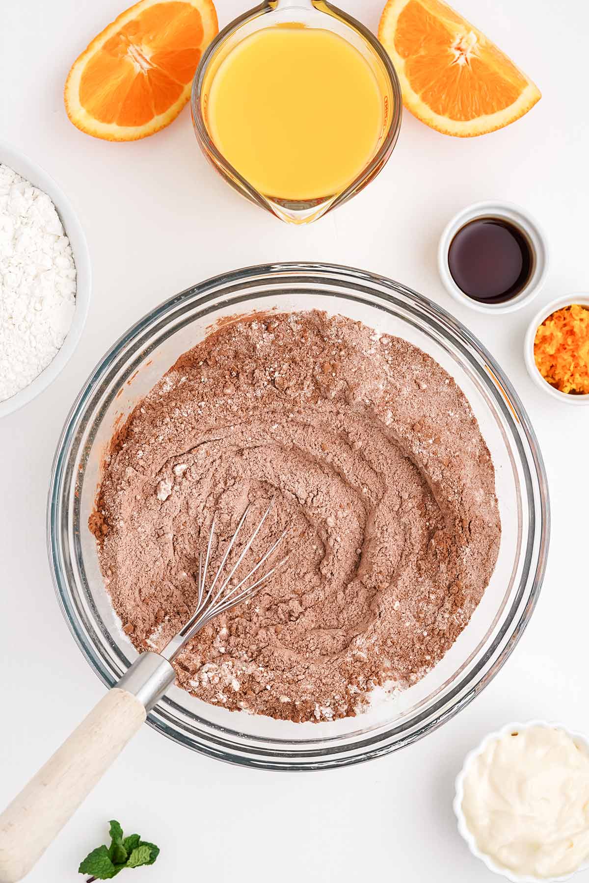 Mixing the dry ingredients together to make a chocolate orange cake recipe.