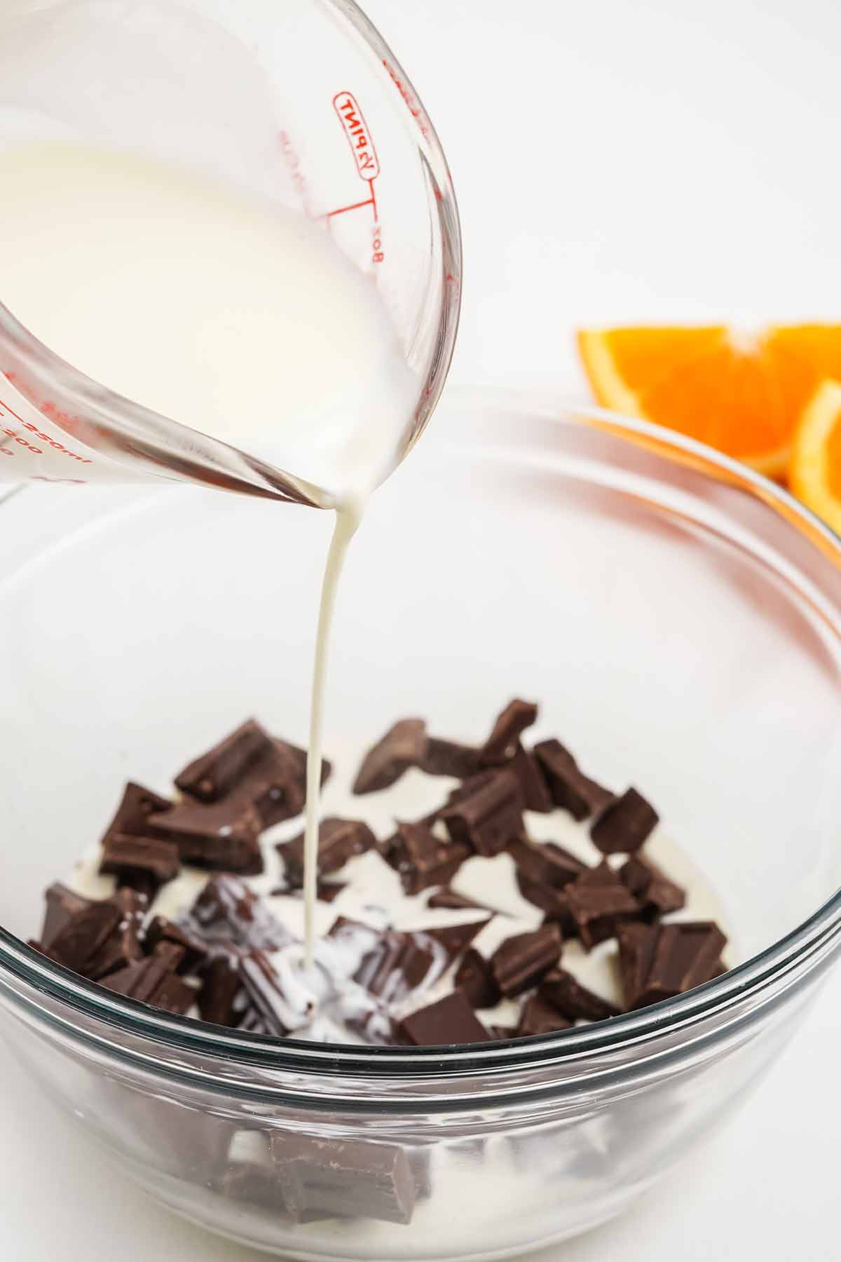 Adding the milk to the chocolate to make ganache.