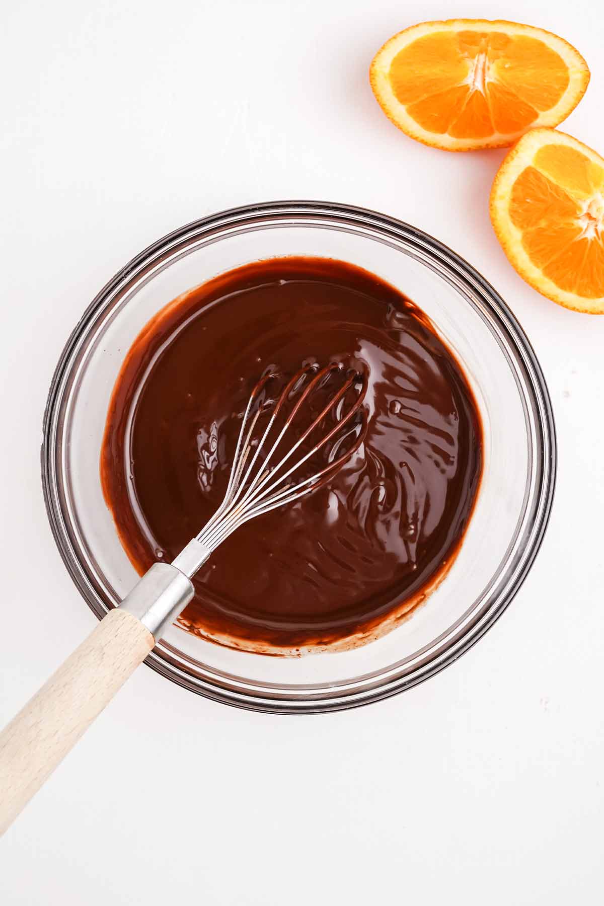 Ganache in a bowl with whisk.