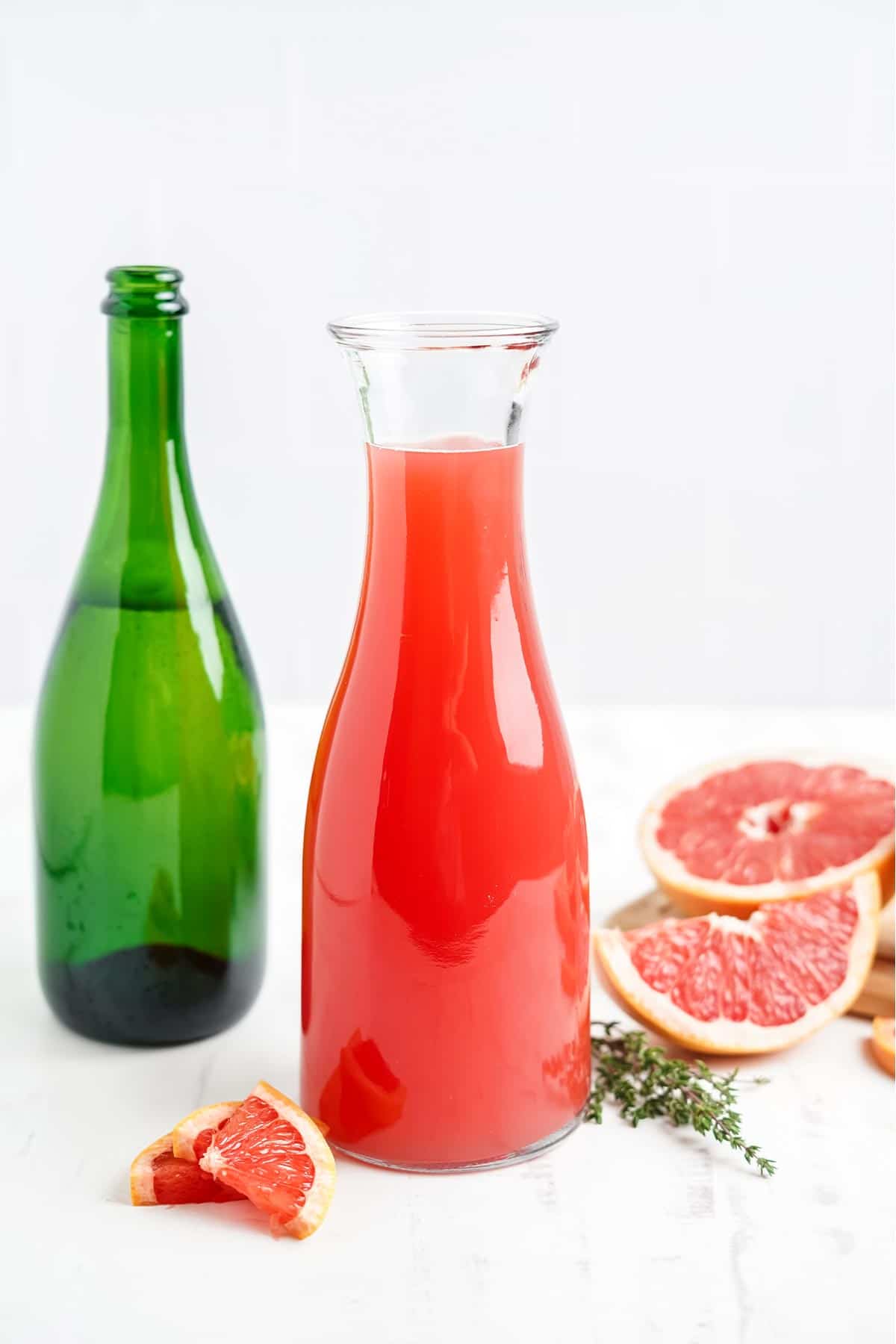 Ingredients to make a pink grapefruit mimosa on the counter.