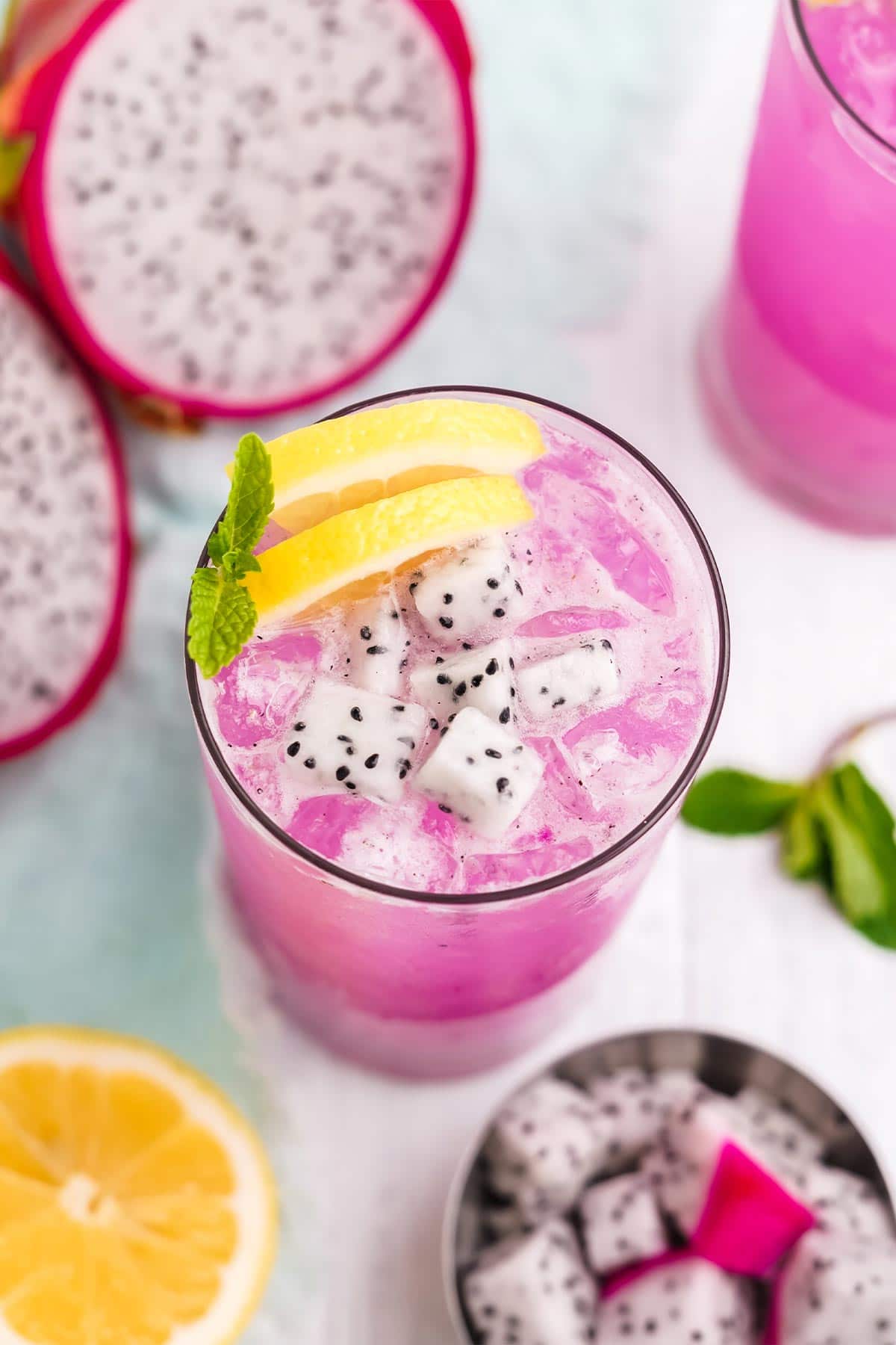 Dragon fruit lemonade with fresh dragon fruit cubes, lemon slices and mint.