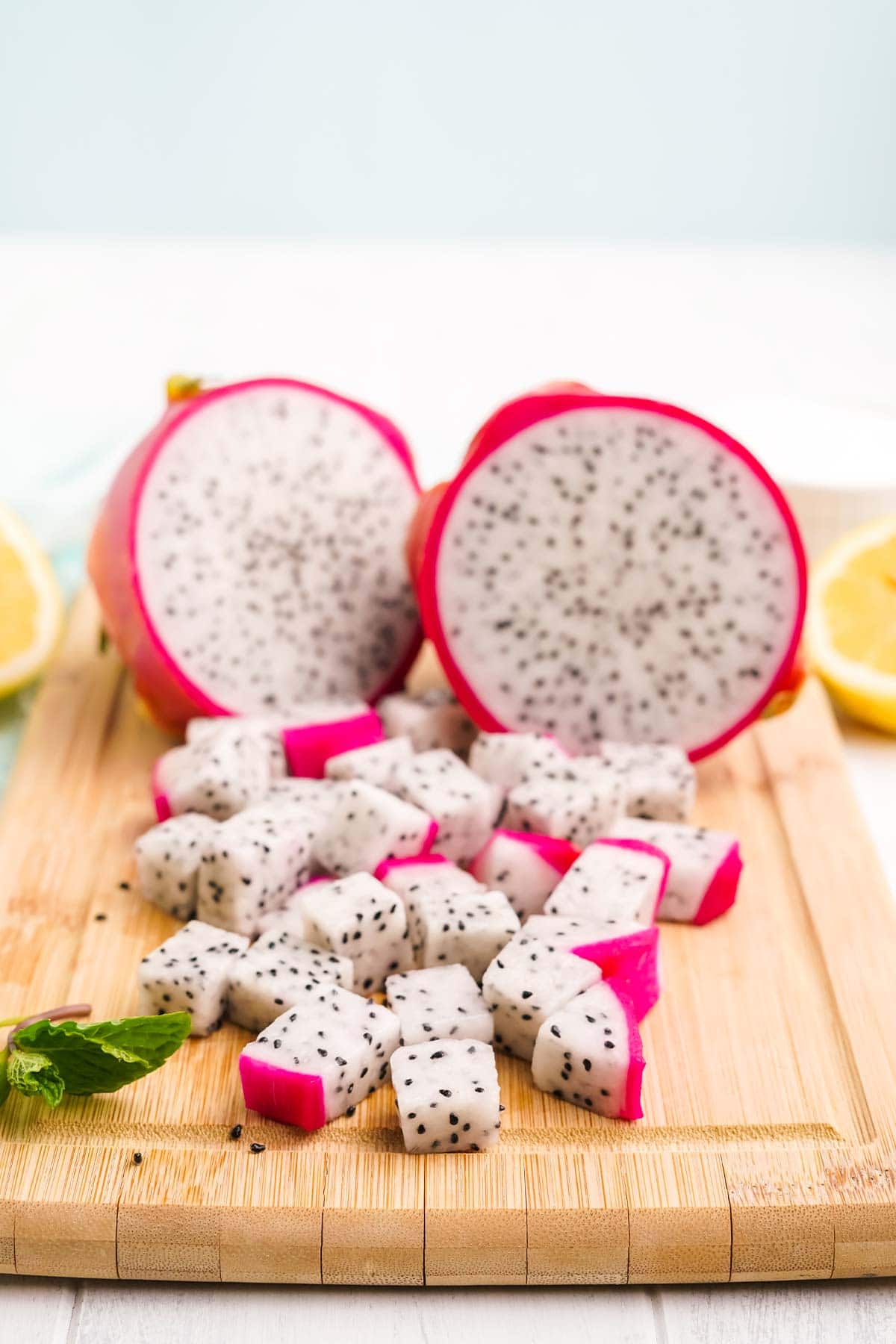 Fresh dragon fruit for lemonade cut up on a cutting board.