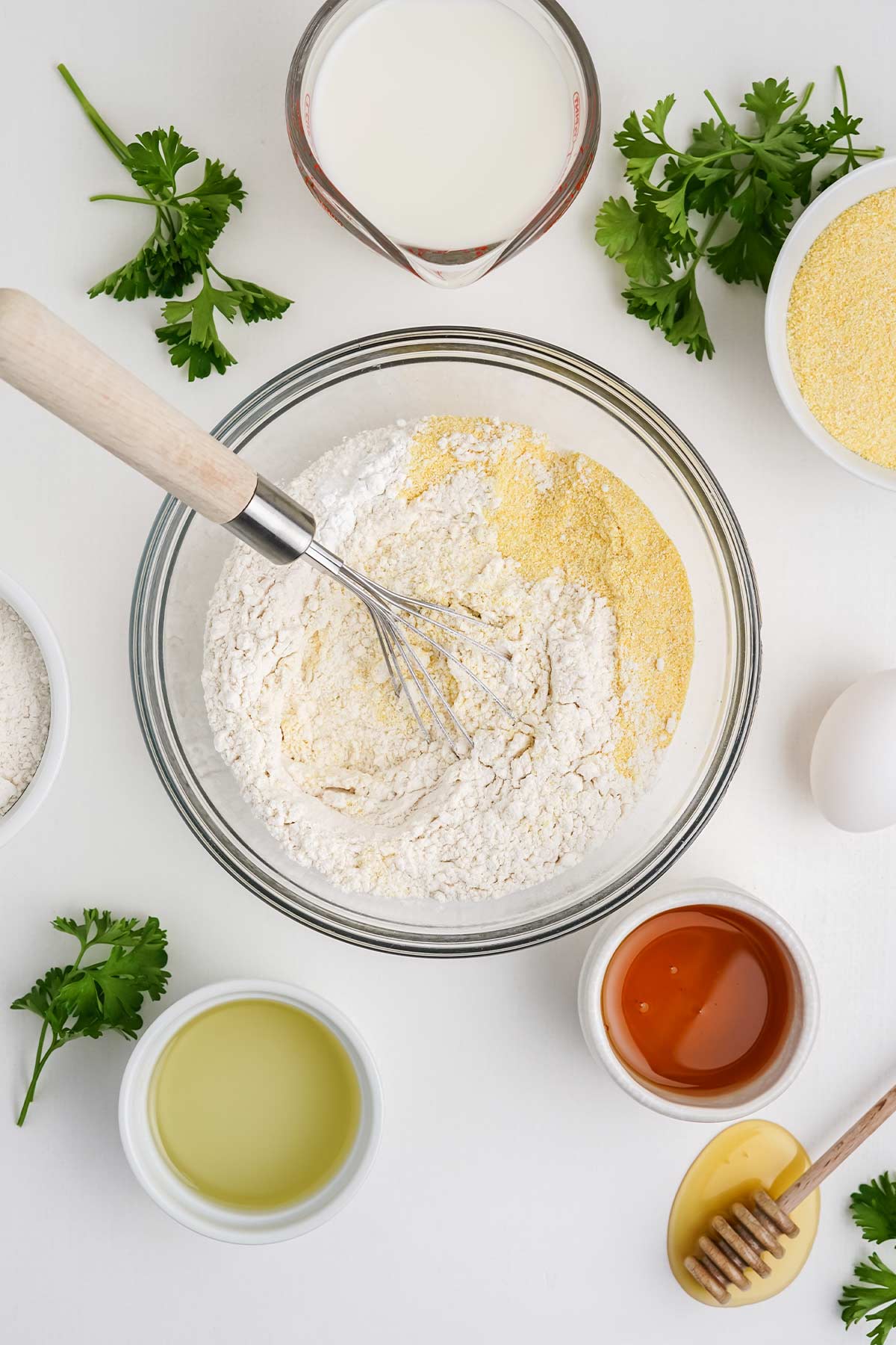 Mixing the dry ingredients for cornbread with honey.