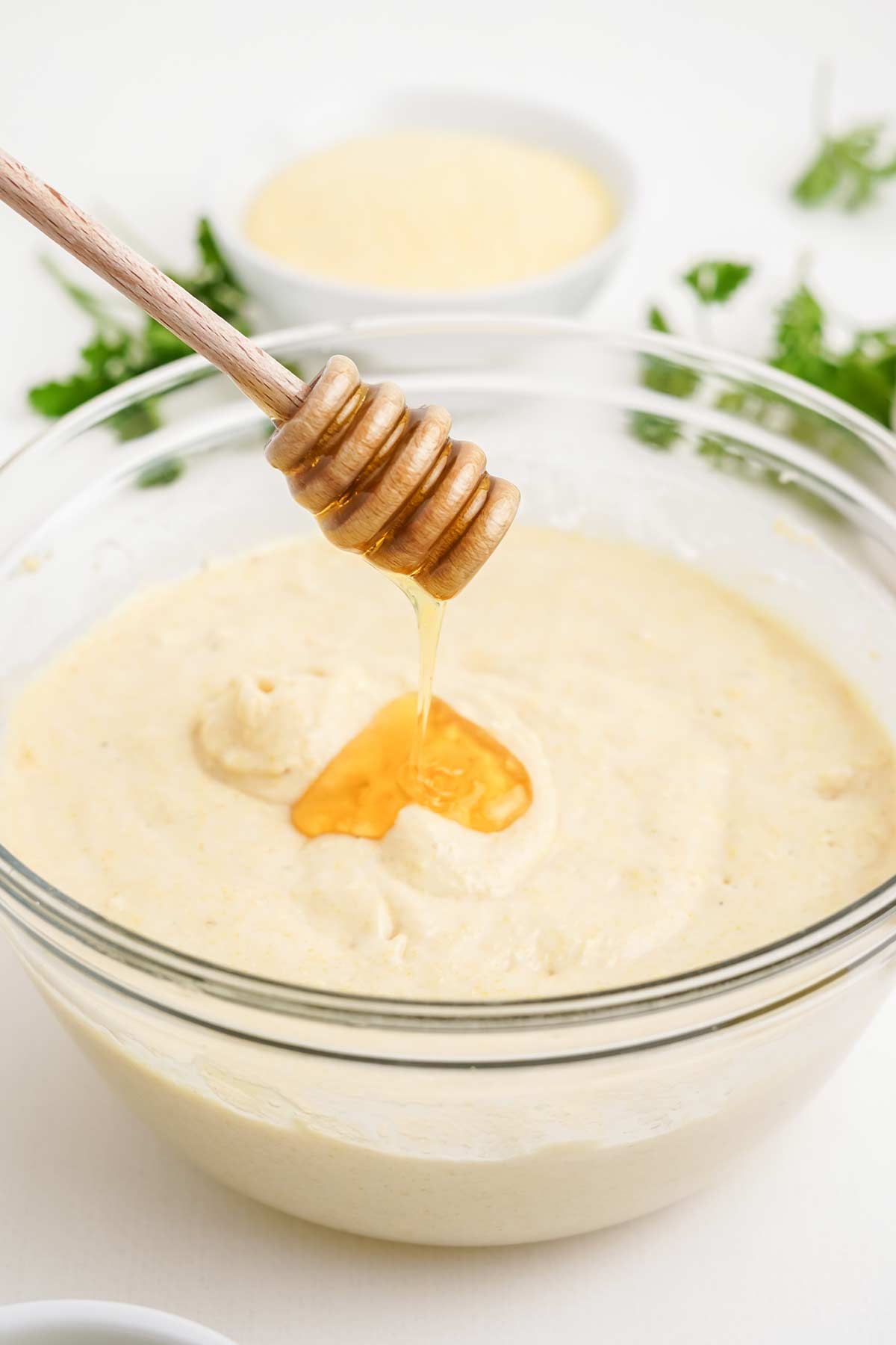 Adding honey to the cornbread batter.