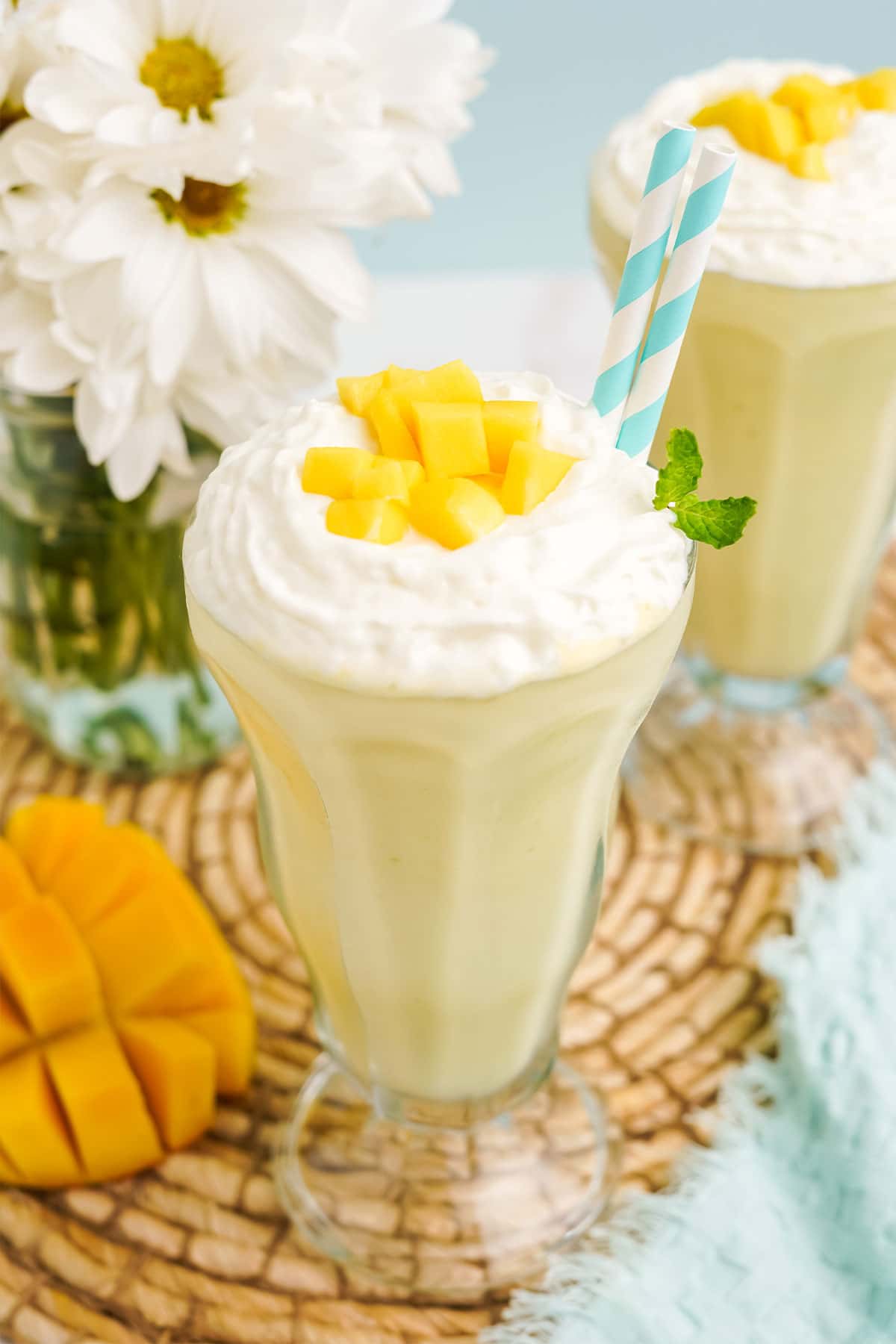 Close up of mango milkshake in a old-fashioned soda glass.